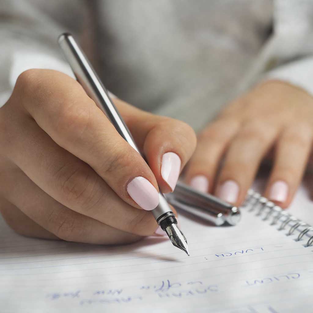 Writing In a journal with a fountain pen
